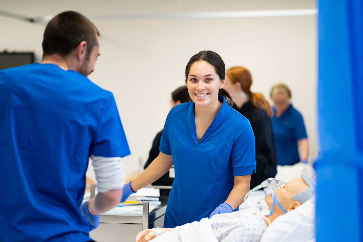 Nursing student participating in a lab class with a manikin at TAFE